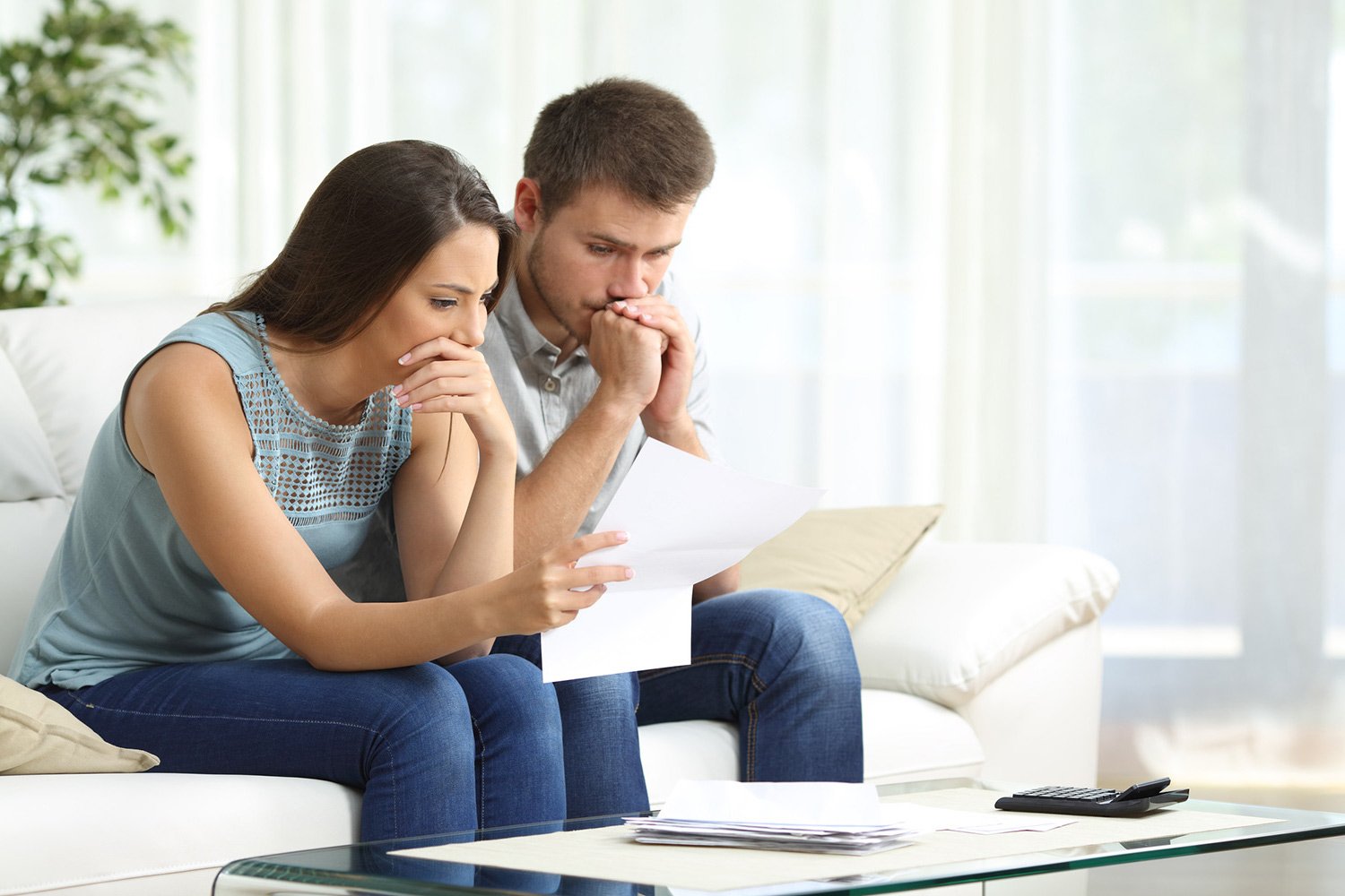 Couple sad after receiving their bills